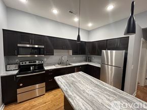 Emmetsburg apartment for rent - A modern kitchen with dark wood cabinets and stainless steel appliances.