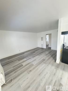 Azusa apartment for rent - A room with wooden flooring and a window letting in sunlight.