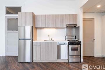 Altoona apartment for rent - A modern kitchen with wooden cabinets and stainless steel appliances.