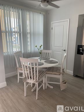 Largo condo for rent - A dining room with a table set for four.