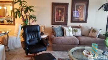 Vero Beach condo for rent - A living room with a black leather chair and a brown couch.