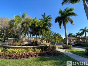 Royal Palm Beach townhouse for rent - A sunny day at a park with palm trees and a sign that says "AVAIL".