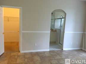 Royal Palm Beach townhouse for rent - A room with a doorway leading to another room and a mirror on the wall.