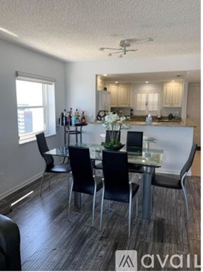 Clearwater condo for rent - A modern dining room with a glass table and chairs.