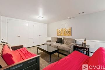 Fort Collins house for rent - A living room with a couch, chair, and a painting on the wall.