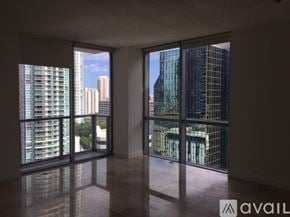 Miami apartment for rent - A room with large windows overlooking a cityscape.