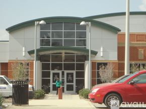 Norfolk apartment for rent - A red car is parked in front of a building with a green roof.