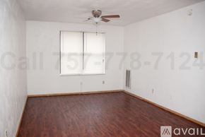 Norfolk apartment for rent - A room with a wooden floor and a ceiling fan.