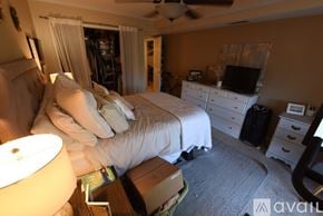 Birmingham apartment for rent - A bedroom with a bed, dresser, and ceiling fan.