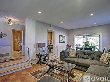 Anaheim apartment for rent - A living room with a grey couch and a coffee table.