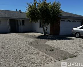 Lompoc apartment for rent - A house with a tree in front and a car parked in the driveway.