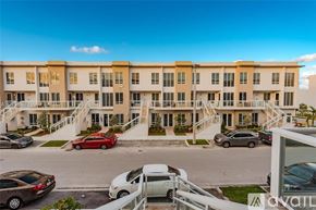 Doral apartment for rent - A multi-story apartment building with a parking lot in front.