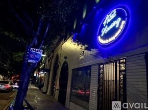 Los Angeles apartment for rent - A blue lit up sign for "Ask Showing" is on a building.