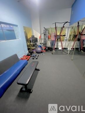 Los Angeles apartment for rent - A gym with a bench, weights, and exercise equipment.