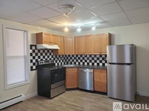 Williamsport house for rent - A kitchen with black and white checkered tiles on the wall.