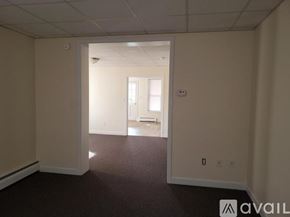 Williamsport house for rent - A room with a carpeted floor and a doorway leading to another room.