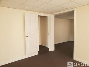 Williamsport house for rent - A room with a carpeted floor and a doorway leading to another room.