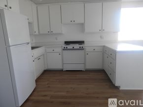 Landers apartment for rent - A kitchen with white appliances and cabinets.