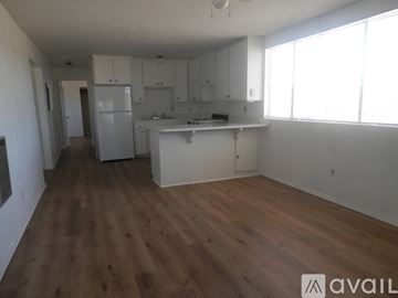 Landers apartment for rent - A kitchen with white cabinets and a wooden floor.