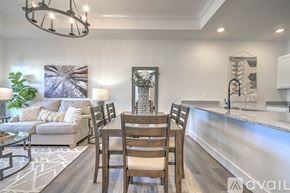 Jonesborough apartment for rent - A modern dining room with a glass table and chairs.
