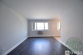 Chicago apartment for rent - A room with a window and a wooden floor is available for rent.