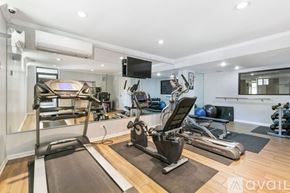 Chicago apartment for rent - A well-equipped home gym with a treadmill, exercise bike, and other fitness equipment.
