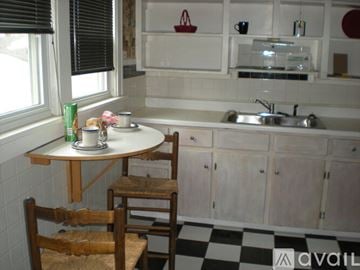 Lakewood house for rent - A kitchen with a checkered floor and a table with two chairs.
