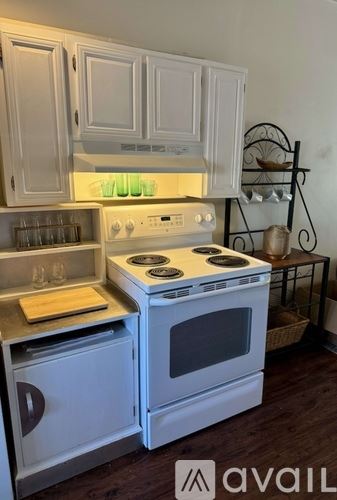 Newburyport apartment for rent - A white stove and oven in a kitchen with wooden floors.