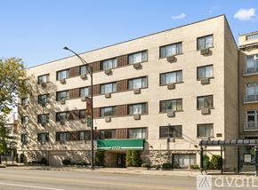 Chicago apartment for rent - A large beige building with a green awning on the front.