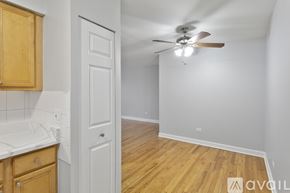Chicago apartment for rent - A room with a ceiling fan and wooden flooring.