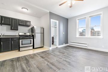 Chicago apartment for rent - A spacious kitchen with a refrigerator, oven, and microwave.