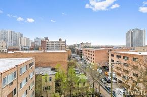 Chicago apartment for rent - A view of a cityscape with buildings and cars.