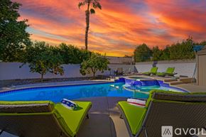 La Quinta house for rent - A pool with lounge chairs and a palm tree in the background.