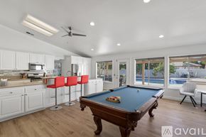 La Quinta house for rent - A pool table in a room with a kitchen area.