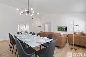La Quinta house for rent - A dining room with a white table and black chairs.