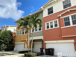 West Palm Beach townhouse for rent - A house with a palm tree in front of it.