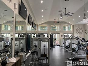 West Palm Beach townhouse for rent - A gym with a variety of equipment including treadmills, weights, and exercise machines.