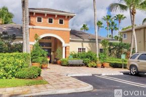 West Palm Beach condo for rent - A house with a car parked in front of it.