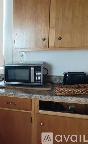 New Orleans apartment for rent - A kitchen with wooden cabinets and a microwave on the counter.