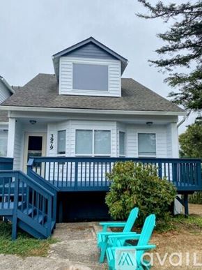 Neotsu house for rent - A house with a blue front porch and two green chairs in front.