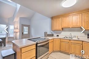 Neotsu house for rent - A kitchen with wooden cabinets and a stainless steel oven.