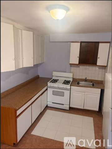 Elizabeth apartment for rent - A kitchen with white appliances and brown countertops.