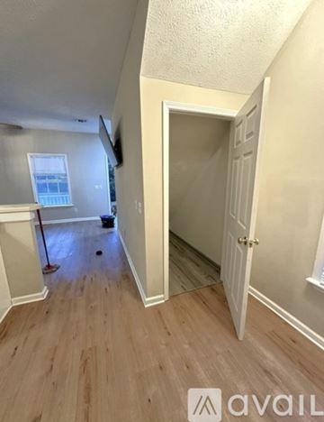 Starkville apartment for rent - A living room with a grey couch and a red and black plaid blanket.
