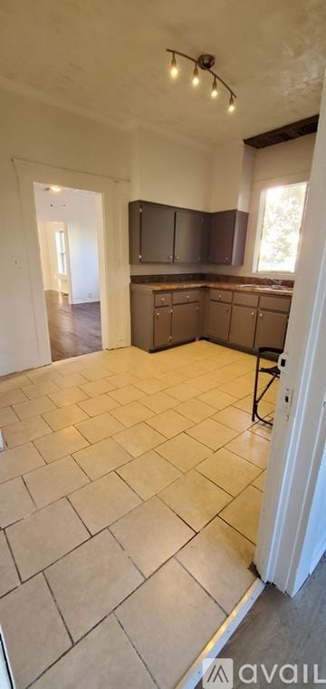 Birmingham house for rent - A kitchen with tile flooring and a countertop.