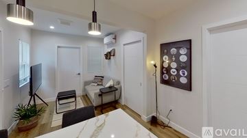 North Hollywood apartment for rent - A modern living room with a white couch and a television.