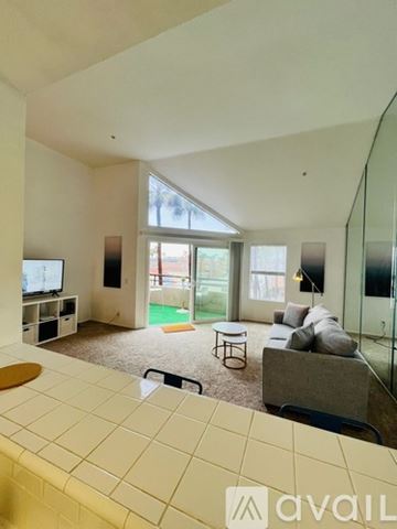 Huntington Beach condo for rent - A living room with a television and a couch.