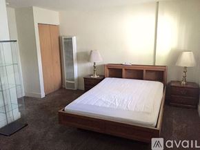 Placentia apartment for rent - A bedroom with a bed, nightstands, and a wardrobe.
