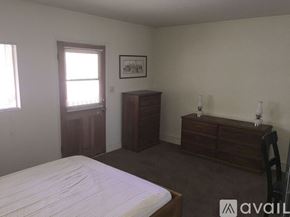 Placentia apartment for rent - A bedroom with a bed, dresser, and nightstand.