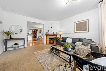 Tacoma apartment for rent - A living room with a grey couch and a glass coffee table.