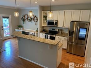 Apex townhouse for rent - A kitchen with granite countertops and stainless steel appliances.